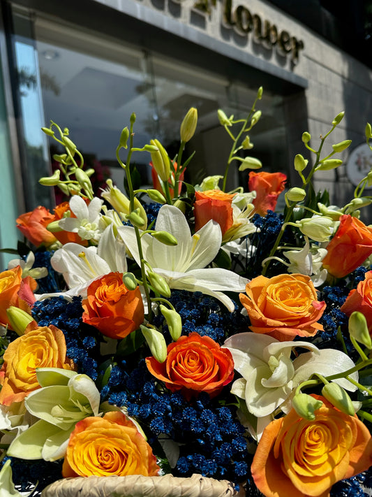 Orange Basket with Blue Baby Flowers